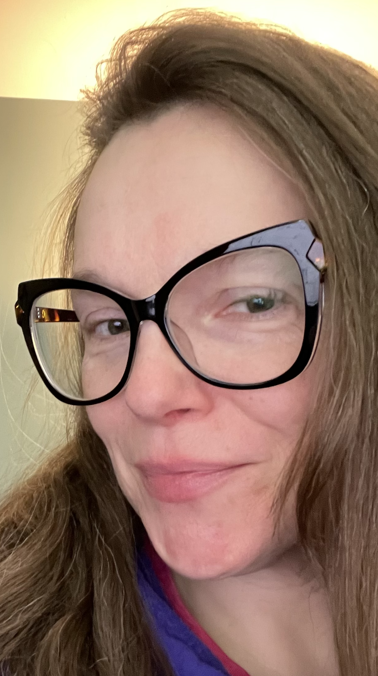 A picture of Miranda. A woman with large black glasses and long light brown hair.